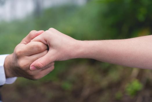 Newly-married couple holding hands