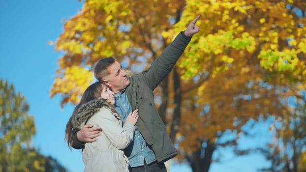 Happy and in love young couple in the park in the fall