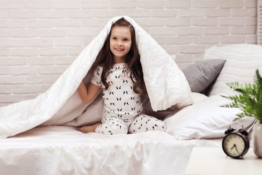 happy morning baby in bed. child dabbles in bed
