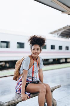 Tourists african american are showing happy expressions while waiting for their journey in the train station