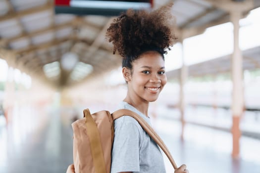 Tourists african american are showing happy expressions while waiting for their journey in the train station