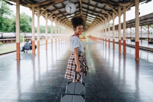 Tourists african american are showing happy expressions while waiting for their journey in the train station