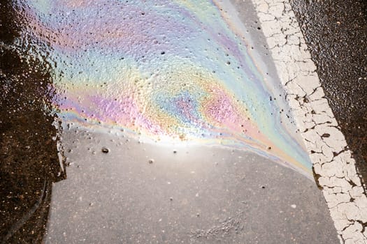 Oil stain or gasoline caused by a leak under a car. Environmental pollution concept. Selective focus