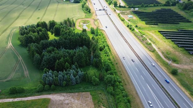 Aerial view of the A7 motorway in northern Germany with big solar panel areas close to the highway
