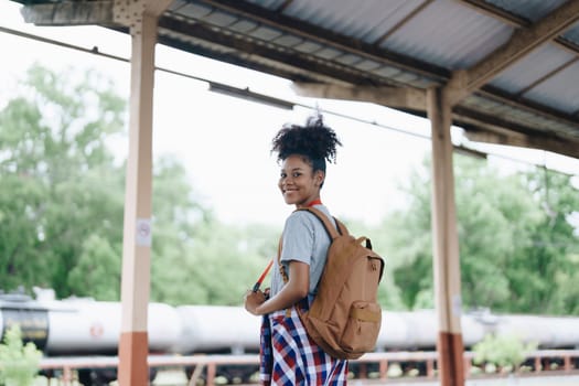 Tourists african american are showing happy expressions while waiting for their journey in the train station