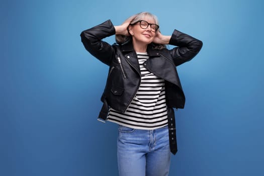 energetic mature woman in a stylish jacket on a bright background.