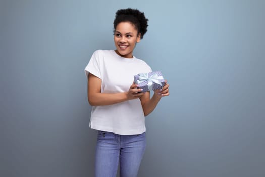 young latin brunette lady in white t-shirt is happy to receive surprise gift for valentine's day.