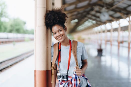 Tourists african american are showing happy expressions while waiting for their journey in the train station