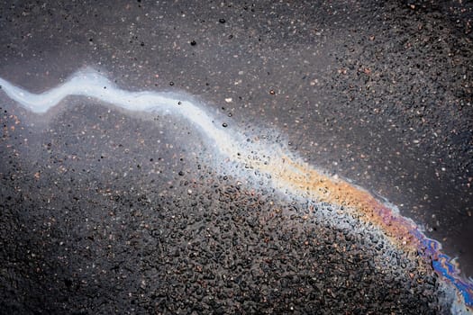 .Abstract background from motor oil, gas or petrol spilled on asphalt. Concept of environmental problems.