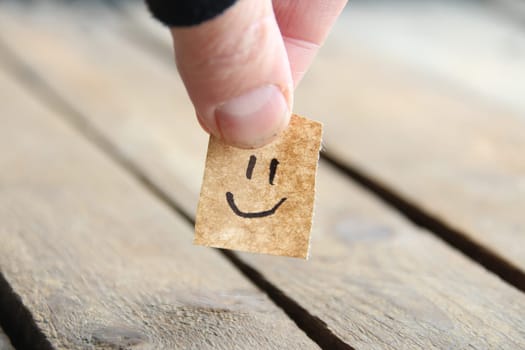 Smiley face on old wooden background, copy space.