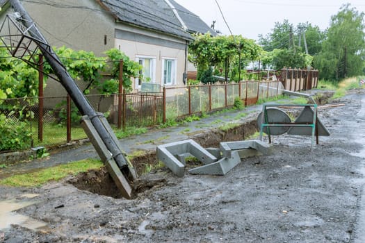 As a result of heavy rain , several electric poles collapsed onto people's fences. Heavy rains caused significant damage to electric poles and resulted in a disruption of power supply.