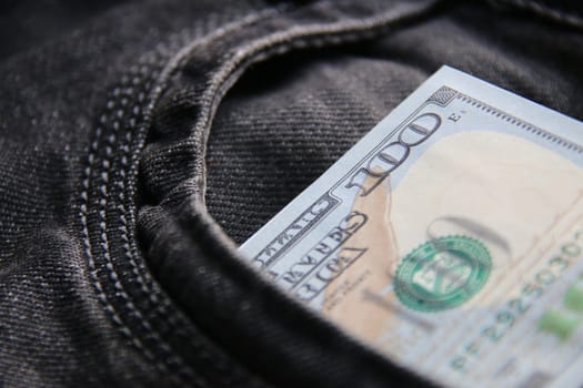 Dollars in a jeans pocket, closeup.