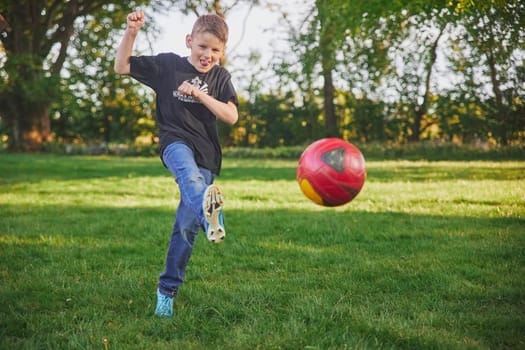 Skjern, Denmark, May 21, 2023: Boy playing football in the backyard.
