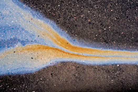 Waste from the oil industry flows down the storm drain with rainwater.