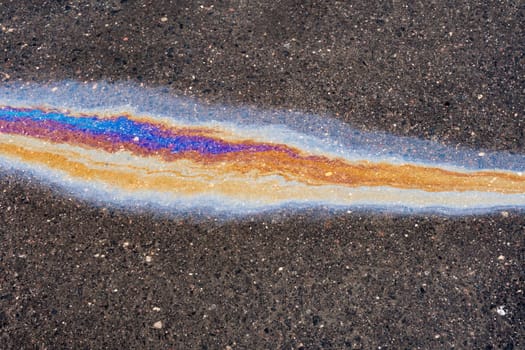 Waste from the oil industry flows down the storm drain with rainwater. Oil petrol water pollution.
