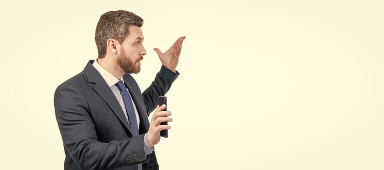 Dont bother me. Angry businessman hold smartphone. Business call. Mobile call. Man face portrait, banner with copy space. Business man in suit, isolated studio background