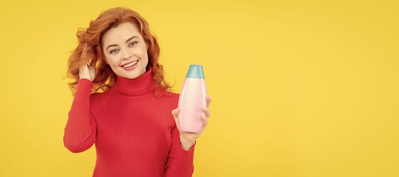 Beautiful woman with organic shampoo over light yellow background