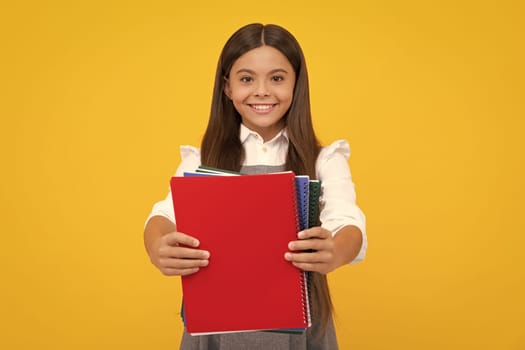 Schoolgirl with copy book posing on isolated background. Literature lesson, grammar school. Intellectual child reader. Happy girl face, positive and smiling emotions