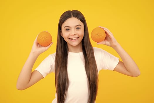 Teen girl with grapefruit. Vitamin and fruits. Child eating orange. Happy teenager portrait. Smiling girl