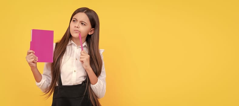 Thoughtful child think holding school book and pen yellow background, thinking. Banner of schoolgirl student. School child pupil portrait with copy space