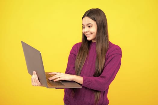 Teenager school girl hold notebook laptop. School children on isolated studio background