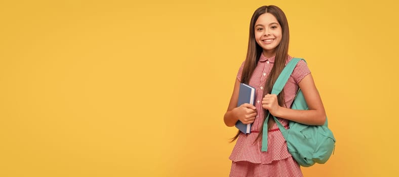 happy kid with workbook on yellow background. Banner of schoolgirl student. School child pupil portrait with copy space