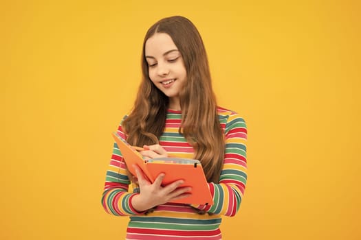 Schoolgirl with copy book posing on isolated background. Literature lesson, grammar school. Intellectual child reader