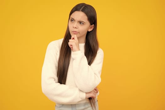 Thinking teenager girl, thoughtful emotion. Smart nerdy school girl touching cheek and thinking against yellow background. Child think and idea concept