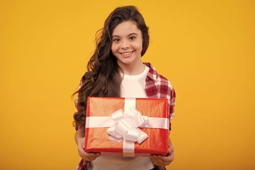 Cute child girl congratulate with valentines day, giving romantic gift box. Present, greeting and gifting birthday concept. Happy teenager, positive and smiling emotions of teen girl