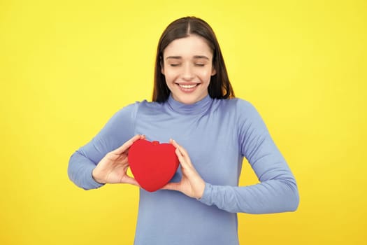 Love sign symbols for happy womens, valentines day or birthday. Beautiful amazing woman cuddle paper card heart shape, dreamy isolated on yellow background. Love concept