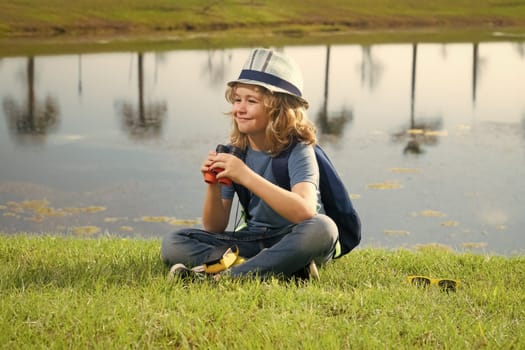 Child tourists with backpacks. Adventure, travel, and tourism concept. Kid walking with backpacks on nature. Little explorer on trip