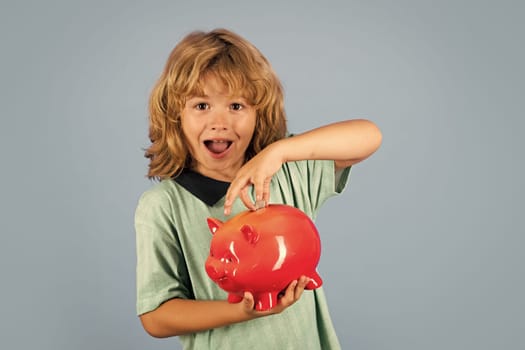 Saving money concept. Child boy putting in piggy bank usd coin