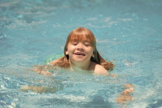 Happy child playing in swimming pool. Summer kids vacation