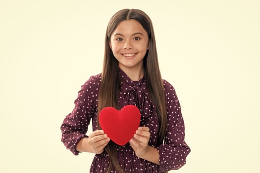 Lovely child girl 12, 13, 14 years old with shape heart love holiday and valentine symbol. Birthday day. Portrait of happy smiling teenage child girl with red heart isolated on white background