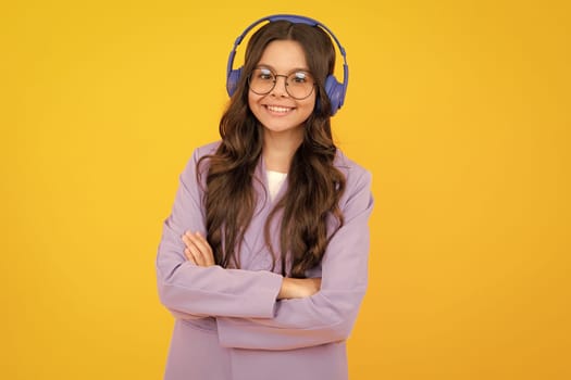 Stylish teenage girl listening to music with headphones. Kids lifestyle concept. Wireless earphones