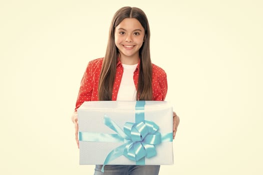 Portrait of happy smiling teenage child girl. Teenager kid with present box isolated on white background. Teen girl giving birthday gift. Present, greeting and gifting concept