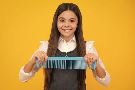 Teen girl girl with brush combing hair. Girl taking haircare and hairstyle. Hairdresser hair solon for teenager