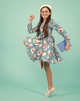 Teenager school girl with books isolated studio background. Happy teenager, positive and smiling emotions