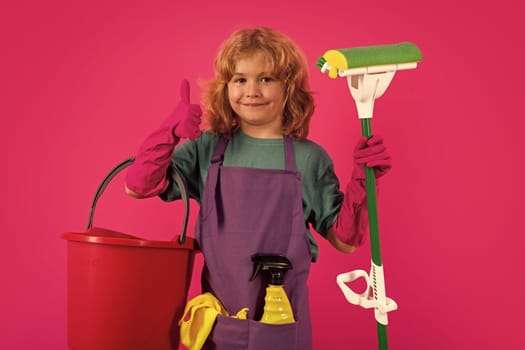 Portrait of child cleaning, concept growth, development, family relationships. Housekeeping and home cleaning concept. Child use duster and gloves for cleaning. Studio isolated background