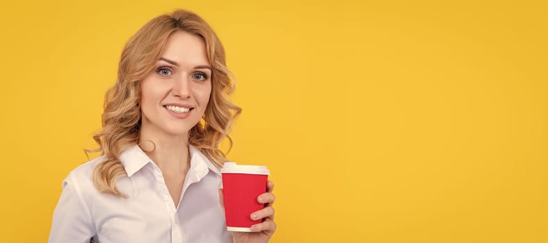 cheerful blonde woman with coffee cup and pc on yellow background. Woman isolated face portrait, banner with mock up copy space