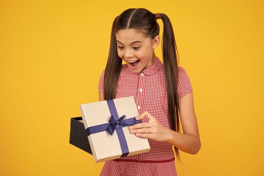 Teenager child with gift box. Present for holidays. Happy birthday, Valentines day, New Year or Christmas. Kid hold present box. Happy teenage girl, positive and smiling emotions
