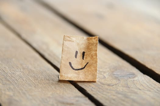 Smiley face on old wooden background, copy space.