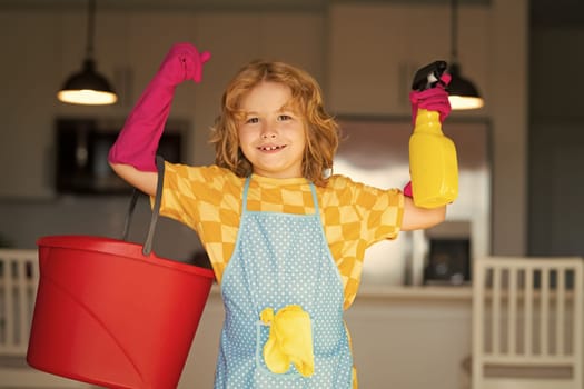 Child use duster and gloves for cleaning. Funny child mopping house. Cleaning accessory, cleaning supplies. Housekeeping and home cleaning