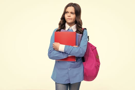 Back to school. School girl student with school backpack hold book on isolated studio background. Kids education concept. Thinking teenager girl, thoughtful emotion