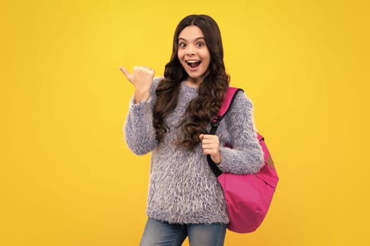 Back to school. Teenager schoolgirl in school uniform with bag. School children on isolated studio background. Happy teenager, positive and smiling emotions of teen girl