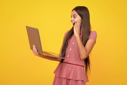 Amazed teen girl. Young student school girl, studying with laptop computer. E-learning concept. Excited expression, cheerful and glad