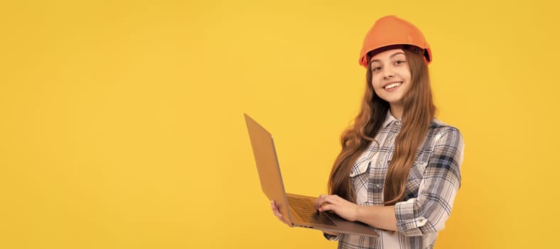 happy teen girl in helmet and checkered shirt using laptop, education online. Child builder in helmet horizontal poster design. Banner header, copy space