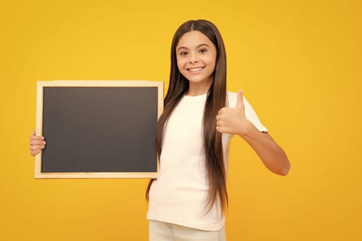 Teen schoolgirl hold blackboard. Child advertising. Back to school. Happy teenager portrait. Smiling girl