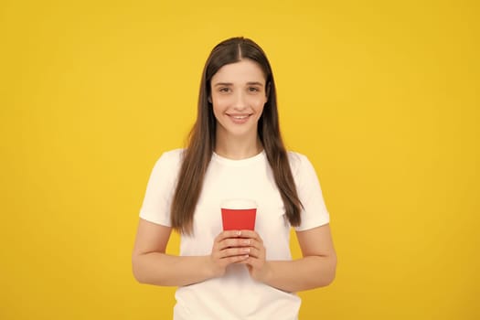 Beautiful young woman enjoying a cup of coffee while relaxing. People, drinks and leisure break, happy young woman with cup of tea or coffee