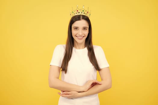 Portrait of young lovely expression woman in crown, isolated studio portrait